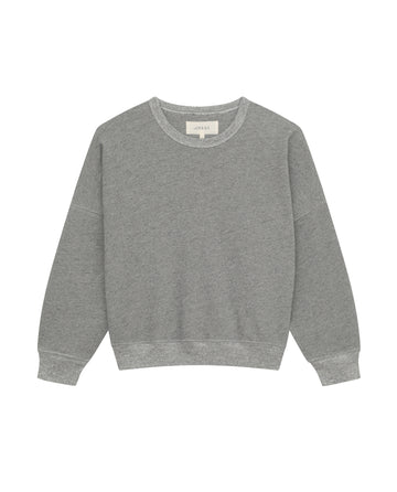 The Teammate Sweatshirt by THE GREAT. FALL21 KNITS, in Varsity Grey, features a relaxed fit, long sleeves, and a round neckline with vintage details. Handcrafted in Los Angeles, this plain grey piece is displayed on a white background.
