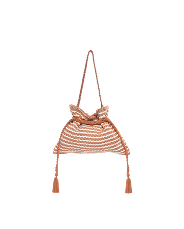 The Cinched Bag by THE GREAT. SU23 is a bohemian hand-woven cotton handbag in Carmel and Cream with a drawstring closure, two handles, and tassel-accented drawstrings for added flair.