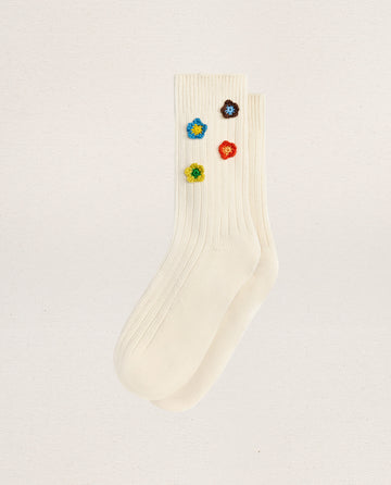 EMME’s THE CROCHET FLOWER SOCK (4 FLOWERS) in cream are ribbed cotton socks accented with four hand-crocheted flower appliques near the top, adding a vintage-inspired touch.