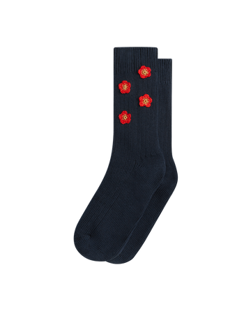 The CROCHET FLOWER SOCK (4 FLOWERS) in navy by EMME features dark blue ribbed cotton and four hand-crocheted flowers near the top, adding vintage charm to your everyday look.