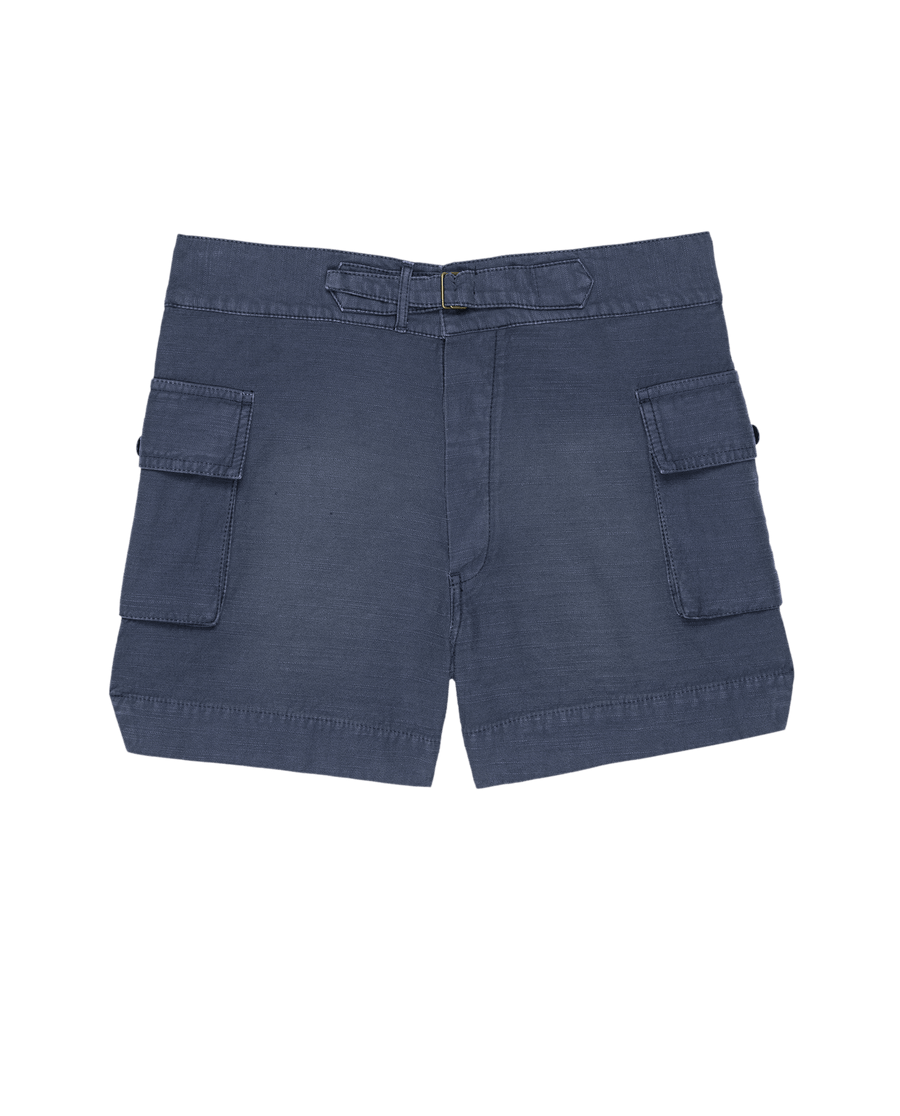 THE GREAT. SU25 The Cargo Fatigue Short in Vintage Blue features two large side pockets, a button closure, and belt loops, shown on a plain background.