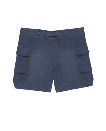 THE GREAT. SU25 The Cargo Fatigue Short in Vintage Blue features two large side pockets, a button closure, and belt loops, shown on a plain background.