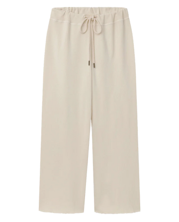 Laid flat against a white background, The Wide Leg Cropped Sweatpant in Washed White from THE GREAT. CORE KNITS features a beige drawstring waist and is made of 100% cotton.