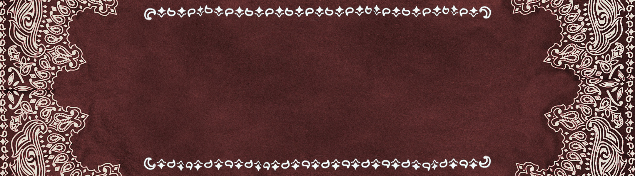 A maroon fabric with intricate white paisley patterns forming a decorative border around the edges.