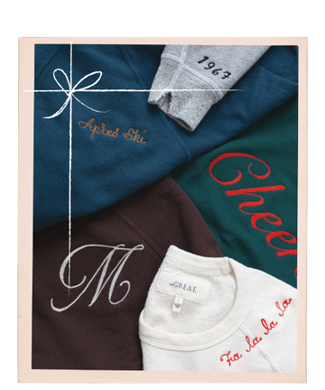 Four folded sweatshirts in different colors, each with embroidered text, are arranged within a frame decorated with a simple white bow illustration.