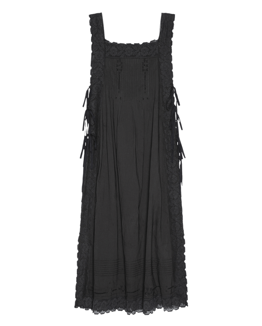 The Attic Lace Dress in black by THE GREAT. SU25 features a sleeveless design, lace trim, square neckline, and ribbon side details, shown against a plain background.