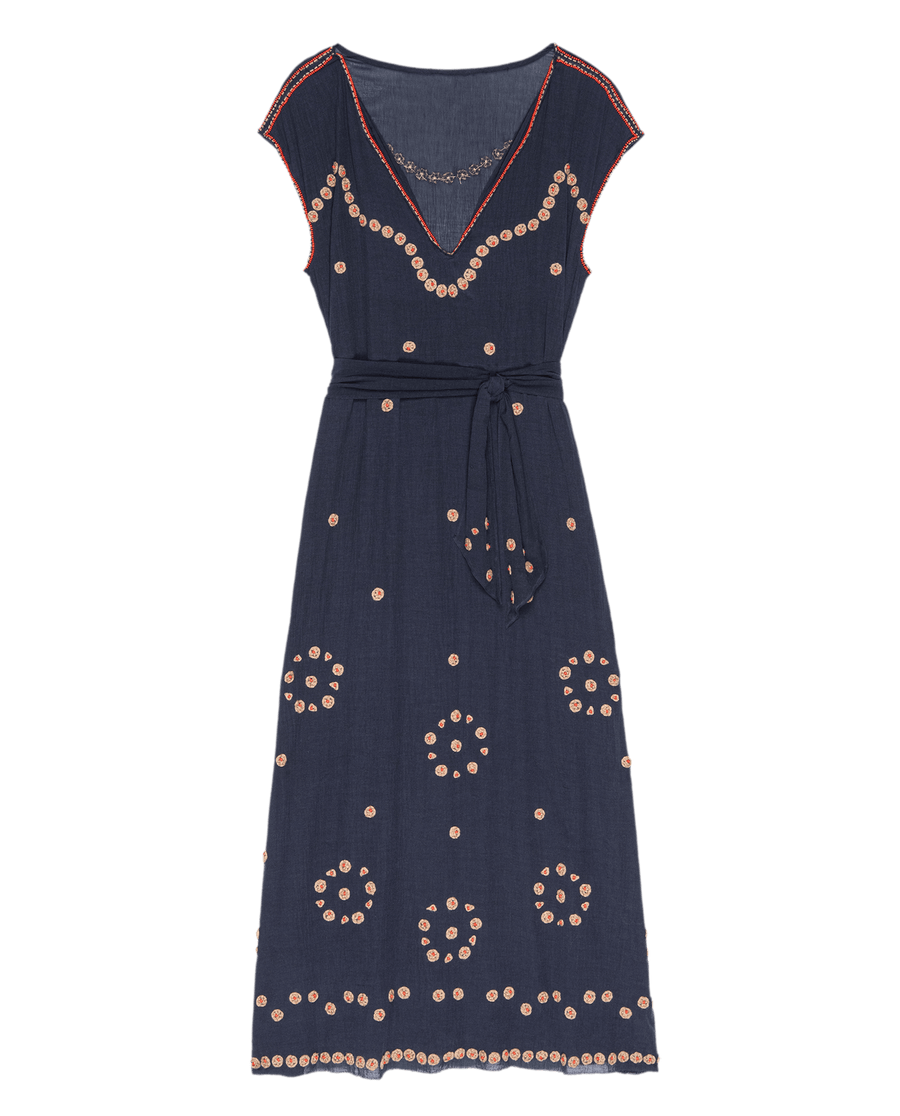 The Beaded Corridor Dress by THE GREAT. SU25 features a navy blue color, cap sleeves, V-neckline, belted waist, and light pink circular embroidery throughout.