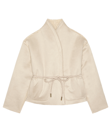 THE GREAT. H25 COLLECTION’s Reversible Drover Coat in Malt features beige long sleeves, a wrap front, front pockets, and a drawstring waist. Shown here on a white background.