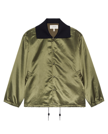 The Satin Coach's Jacket – Bright Army by THE GREAT. H25 COLLECTION features a shiny olive green satin finish, black collar, front pockets, and adjustable drawstrings at the hem.