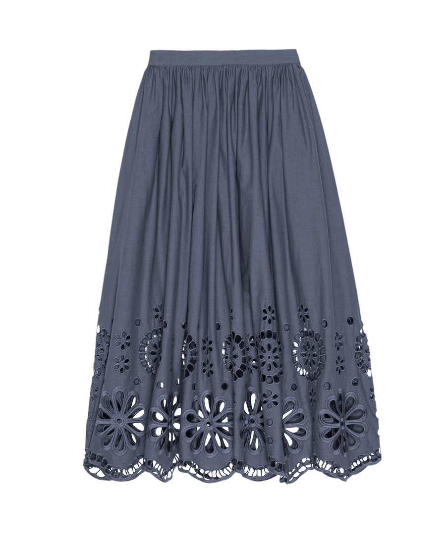 The Super Bloom Eyelet Skirt by THE GREAT. SU25 in Vintage Blue is a knee-length skirt with an elastic waistband and floral cutout embroidery along the hem, inspired by a Super Bloom.