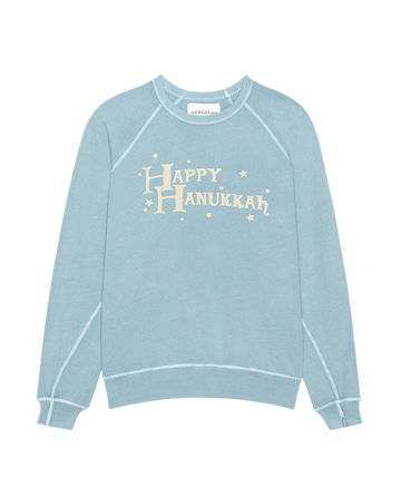 The Little College Sweatshirt by THE GREAT. H25, in Confection Blue, features a "Happy Hanukkah" graphic—perfect for festive celebrations and holiday comfort.
