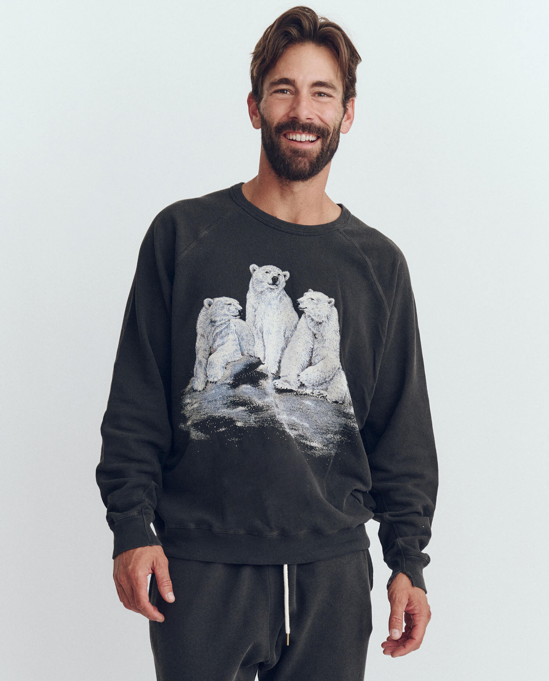The Men's College Sweatshirt. Graphic -- Washed Black with Polar Bear Graphic SWEATSHIRTS THE GREAT. HOL 23 D1 MEN
