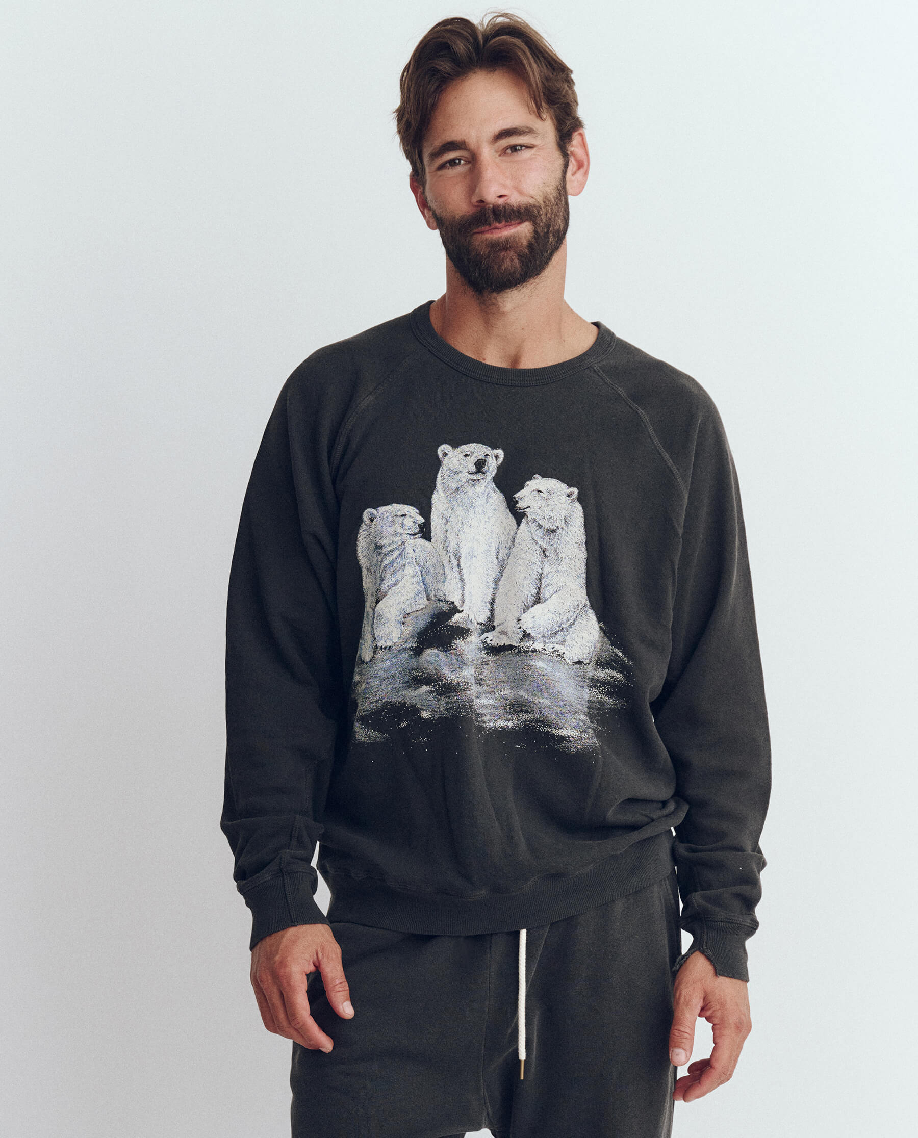 The Men's College Sweatshirt. Graphic -- Washed Black with Polar Bear Graphic SWEATSHIRTS THE GREAT. HOL 23 D1 MEN