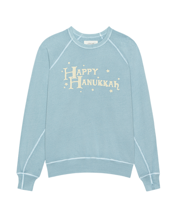 The Mens College Sweatshirt by THE GREAT. H25 MAN HOLIDAY GRAPHICS in Confection Blue features a festive "Happy Hannukah" graphic—perfect for stylish Hanukkah celebrations.