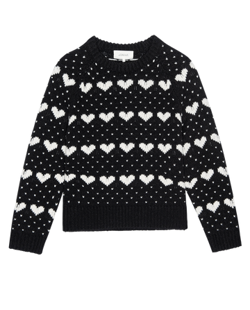 The Heart Crew.--Black With Pearl by THE GREAT. PS26 is a vintage-style wool crewneck sweater with rows of white heart and dot patterns, shown on a plain white background.