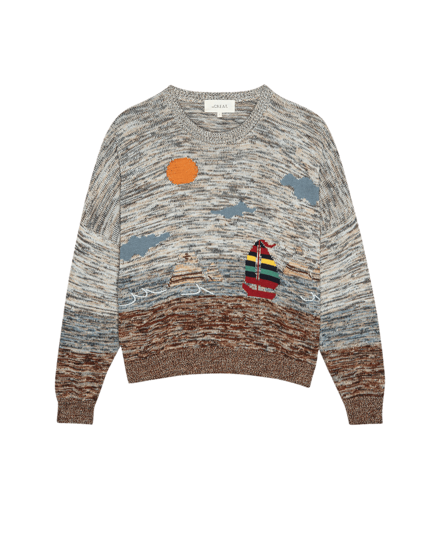 THE GREAT. SU25's The Boating Pullover – Sea Breeze Multi is a knitted sweater with a seascape design featuring a sailboat, water, orange sun, and textured sky in vibrant yarn colors.