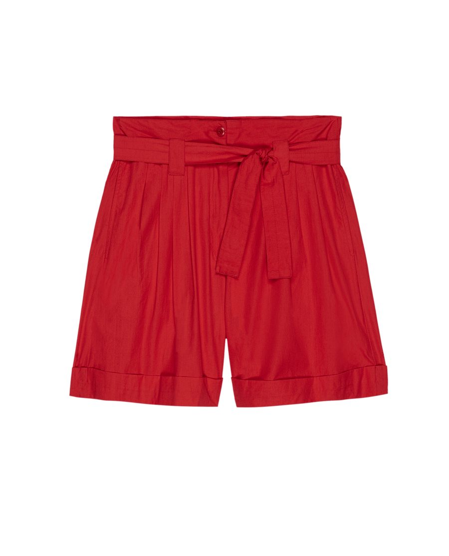 THE GREAT. SU25 'The Pleated Trouser Short' in Hot Red features pleats, a matching fabric belt, button closure, and cuffed hems, shown on a plain white background.