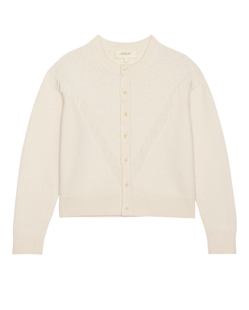 The Beaded Fringe Cardigan in cream by THE GREAT. H25 COLLECTION features long sleeves, button-up front, beaded fringe, and ribbed cuffs and hem, shown on a white background.