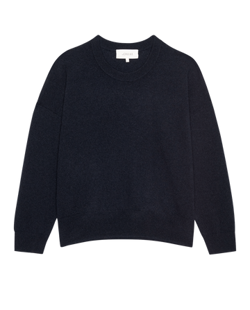 The Cashmere Crew by THE GREAT. H25 CASHMERE in navy is a timeless long-sleeve sweater, laid flat on a white background to highlight its luxurious knitwear.