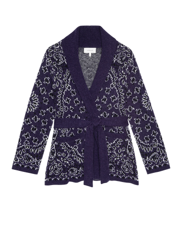 The Bandana Riding Cardigan by THE GREAT. H25 COLLECTION features a navy bandana print, white floral pattern, shawl collar, long sleeves, and a matching waist belt.