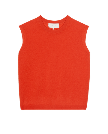 The Cashmere Pullover Vest by THE GREAT. PS26 in Hot Orange is a sleeveless knit style laid flat on a white background, bringing vintage menswear vibes.