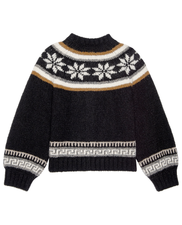 The Snowflake Ice Rink Cardigan by THE GREAT. H25 COLLECTION is a black winter sweater with white and tan snowflakes and geometric horizontal patterns on the chest, sleeves, and hem.