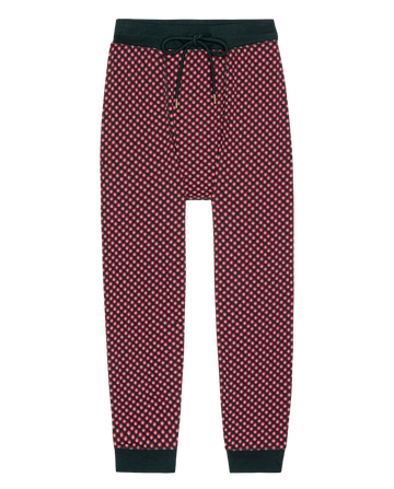 The Jersey Long John in Daisy Tie Print by THE GREAT. H25 SLEEP features red and black patterned jogger pants with a black waistband, drawstring, and ankle cuffs, crafted from soft jersey fabric and shown on a white background.