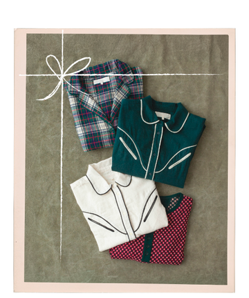 Four folded shirts—one plaid, one green with white trim, one white with black trim, and one red with a dot pattern—are arranged neatly on a flat surface with a drawn ribbon border.