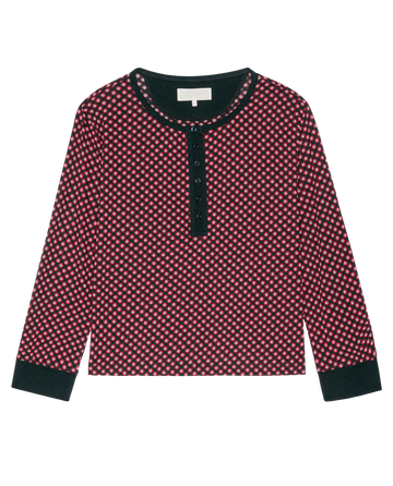 The Crop Sleep Henley by THE GREAT. H25 SLEEP features a long-sleeve, cropped henley style in a red and white Daisy Tie Print with a black collar, cuffs, and button placket, shown laid flat on a white background.