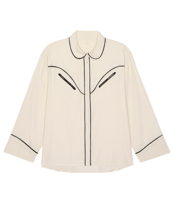 The Flannel Western Pajama Shirt in Cream & Black by THE GREAT. H25 SLEEP features black piping accents on the collar, chest, and cuffs, shown flat against a white background.