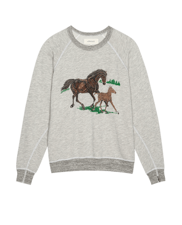 THE GREAT. PF25 The College Sweatshirt in soft heather grey features a running horses motif, with a brown horse and foal walking on grass and green trees illustrated in the background.