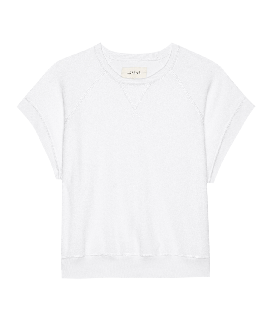The Micro Terry Wedge Sweatshirt by THE GREAT. SU25 MICRO TERRY in True White features short sleeves, a crew neckline, visible stitching, and a straight hem, shown on a white background.