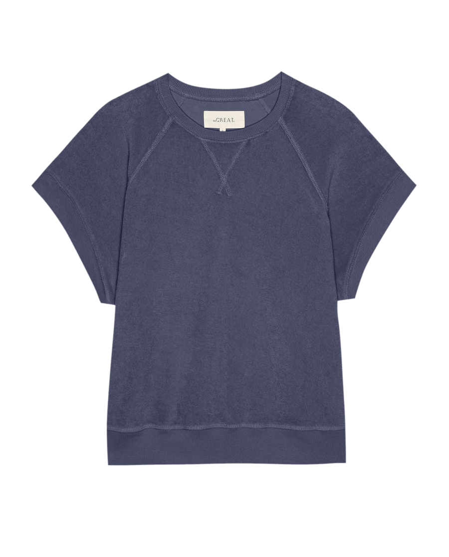 The Micro Terry Wedge Sweatshirt by THE GREAT. SU25 MICRO TERRY features a short-sleeve, crew neck design with raglan seams and a relaxed fit in vintage blue, crafted from soft Micro Terry for all-day comfort.