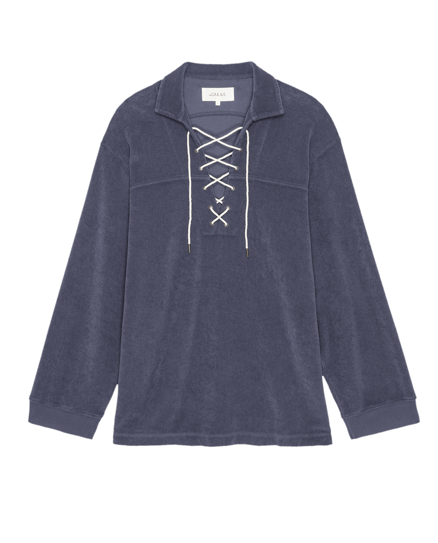 The Micro Terry Lace Up Tunic by THE GREAT. SU25 MICRO TERRY in Vintage Blue is a long-sleeve collared pullover with a stylish white lace-up front detail.