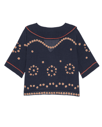 The Beaded Vintage Sailor Top in navy by THE GREAT. SU25 features three-quarter sleeves, red stitching, and circular beige dot patterns for a vintage sailor look.