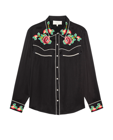 The Heirloom Rose Western Shirt by THE GREAT. H25 COLLECTION features a black long-sleeve design with white piping and vibrant red and green embroidered roses on the collar, chest, and cuffs.