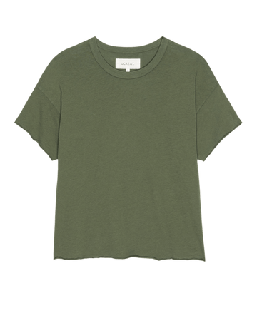 The Crop Tee. Solid -- Heritage Army by THE GREAT. SU25 SEASONAL KNITS: a plain olive green short-sleeve crew neck t-shirt for casual wear, shown on a white background.