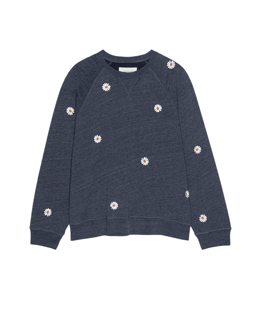 The Slouch Sweatshirt by THE GREAT. SU25 in Heathered Vintage Blue features floating daisy embroidery with white daisy prints, displayed on a plain background.