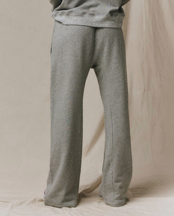 Model wearing SP26 New Knits’ The Horseshoe Sweatpant in Varsity Grey stands with their back to the camera against a neutral backdrop, highlighting comfortable and effortless loungewear style.