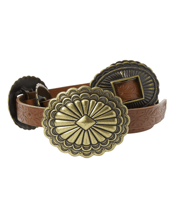 The Tooled Leather Concho Belt by THE GREAT. STETSON SP26 features cognac-colored tooled leather with large, engraved brass buckles and decorative conchos.