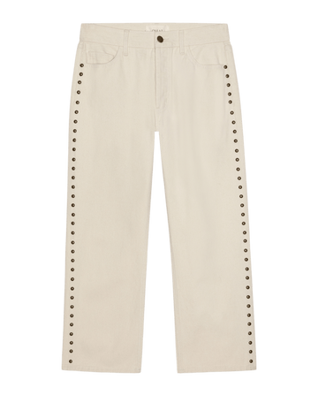 The Studded Wayne Jean by THE GREAT. in Natural features silver rivet details on side seams, front and back pockets, plus a button and zip waist—an elevated twist on classic designer denim.