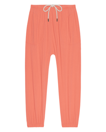 The Jersey Jogger Pant in Guava by THE GREAT. SU26 SEASONAL CORE features an elastic waistband with drawstring, two front pockets, and elastic cuffs, shown laid flat on a white background.