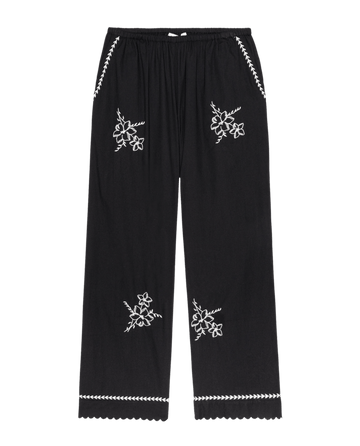THE GREAT.'s The Weekend Pant W/ Hanky Embroidery in black features white hanky embroidery on the front, scalloped hems, and decorative stitching at the pockets and waistband.