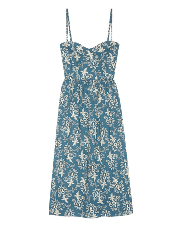 The Verse Dress in Indigo Bandana by THE GREAT. features thin straps, a white floral pattern, a fitted bodice, and a flared skirt.