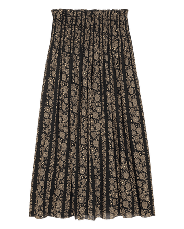 The Canary Skirt by THE GREAT. SU26 features a black and cream token floral print and a gathered elastic waistband, shown laid flat on a white background.
