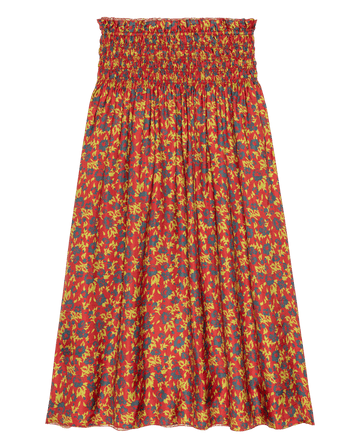 The Canary Skirt by THE GREAT. features a vibrant red midi silhouette with a smocked waistband and a bold floral print in yellow and dark blue.