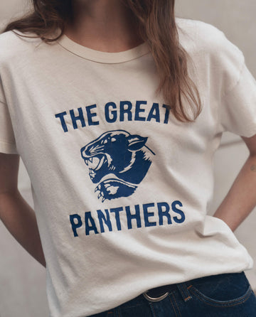 A person wearing THE GREAT. F26 D1 The Boxy Crew w/ Growling Panther Graphic in washed white; their face is not visible.