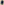 A person in The Men's College Sweatshirt -- True Navy by THE GREAT. FALL 23 MEN and light pants stands with hands in pockets against a beige fabric background.