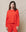 Wearing The Teammate Sweatshirt in Solid Tart by THE GREAT. SP25 KNITS and matching pants, the person stands confidently against a neutral backdrop.