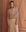 A person in a Dusty Pink Western Slouch Sweatshirt by THE GREAT. SP25 D1 and a lace skirt stands elegantly before an ornate peach-colored door.